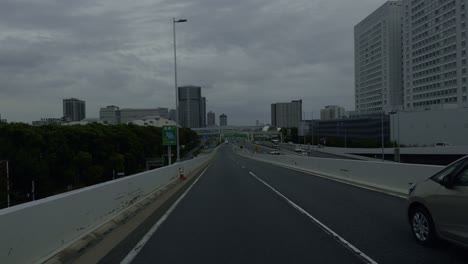 blue hour drive through tokyo’s new territories a serene daytime drive on tokyo’s highway, with a front-seat view of the cloudy blue hour over the new territories