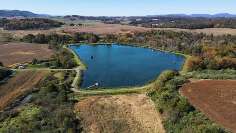 Aerial-push-in-shot-toward-lake-on-plantation-during-autumn