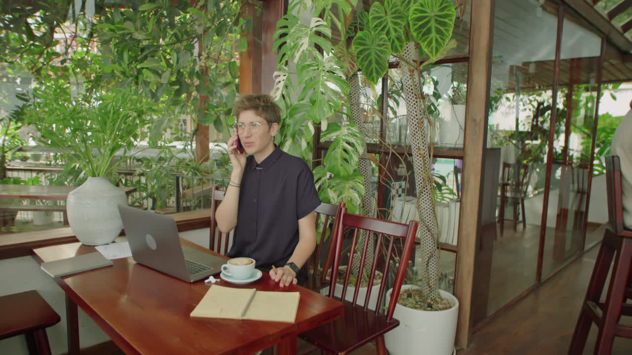 Woman Working Remotely in Outdoor Cafe on Summer Day