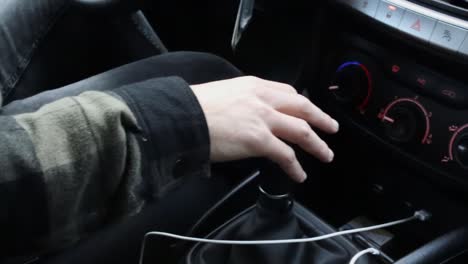 close up of hand shifting car to fourth gear while driving