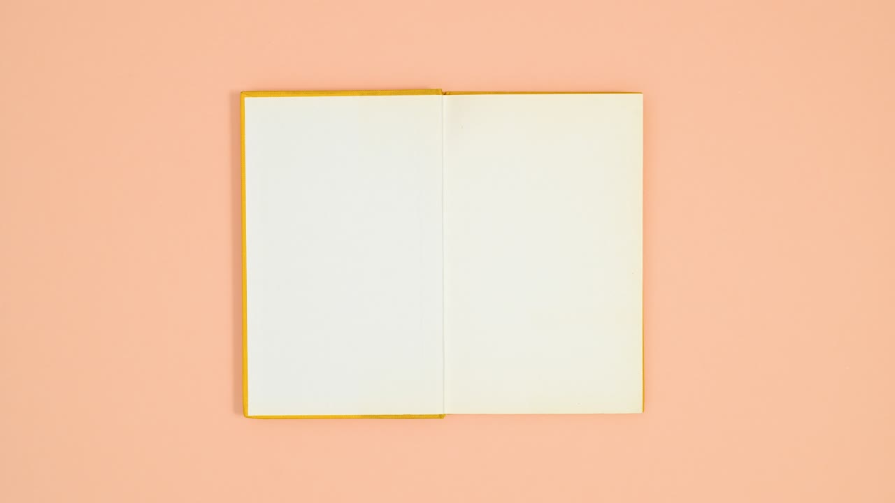 Yellow hardcover book appear on orange theme and opens. Stop motion