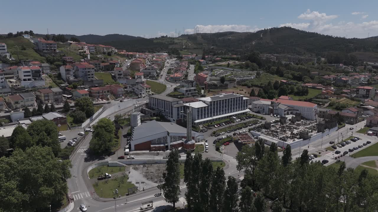 aerial tracking shot of Perafita Church with Porto hills and dense urban sprawl in view