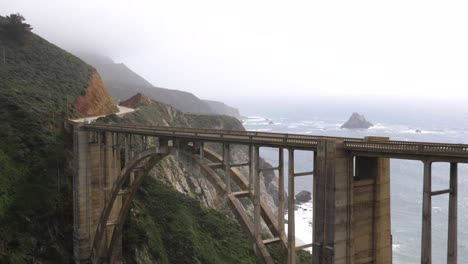 Ultra-slow-motion-shot-of-Bixby-Creek-Bridge-with-view-of-the-ocean-in-California,-USA