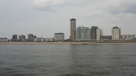 aerial low-elevation approach to the city beach and the skyline in vlissingen, zeeland, the netherlands