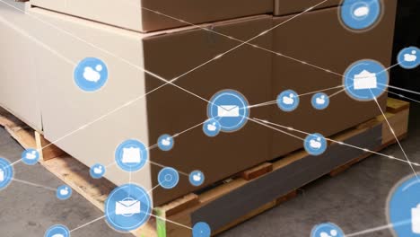 Animation-of-connected-envelope-and-speech-bubble-icons-over-cardboard-boxes-on-pallet-in-warehouse