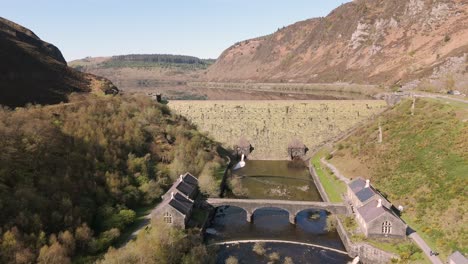 An-aerial-view-of-Caban-Coch-dam-and-reservoir-on-a-sunny-spring-day-in-the-Elan-valley,-Powys,-Wales