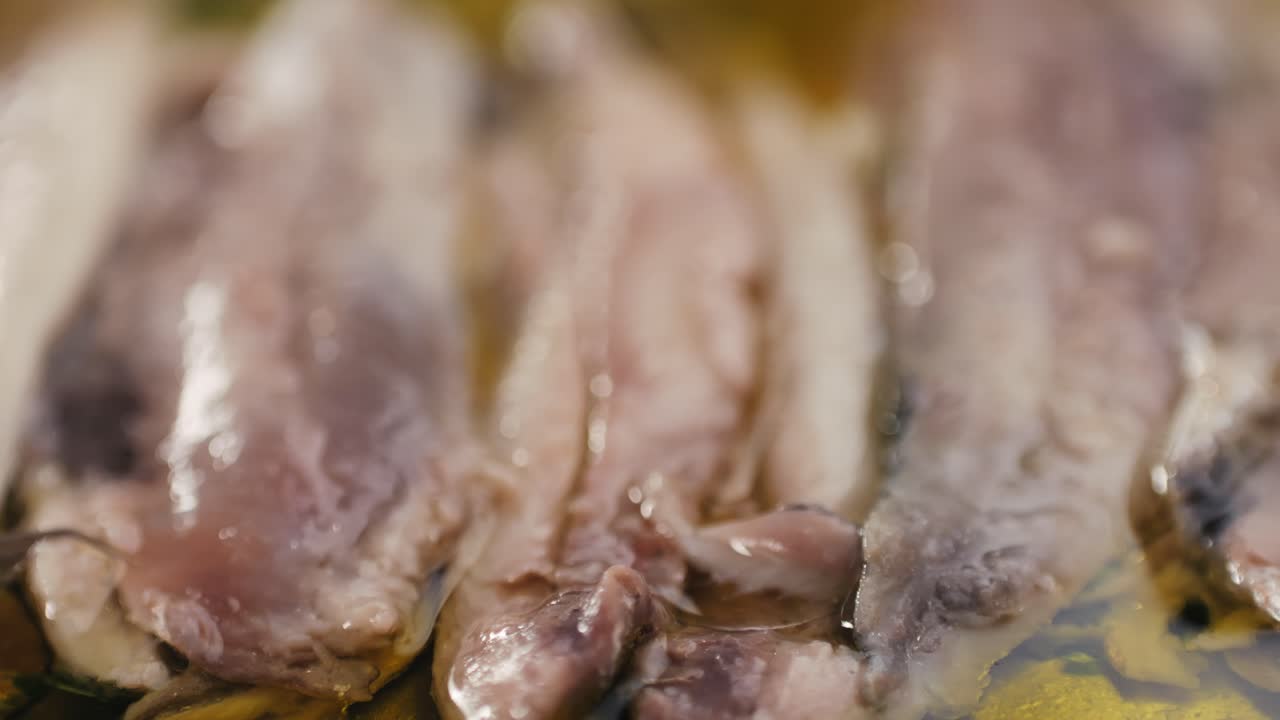 Fresh Sea sardines and Anchovy Fish and Mullus On Display On Ice On Market Store Shop. Seafood Fish Background, close up stand of small salty white fish.