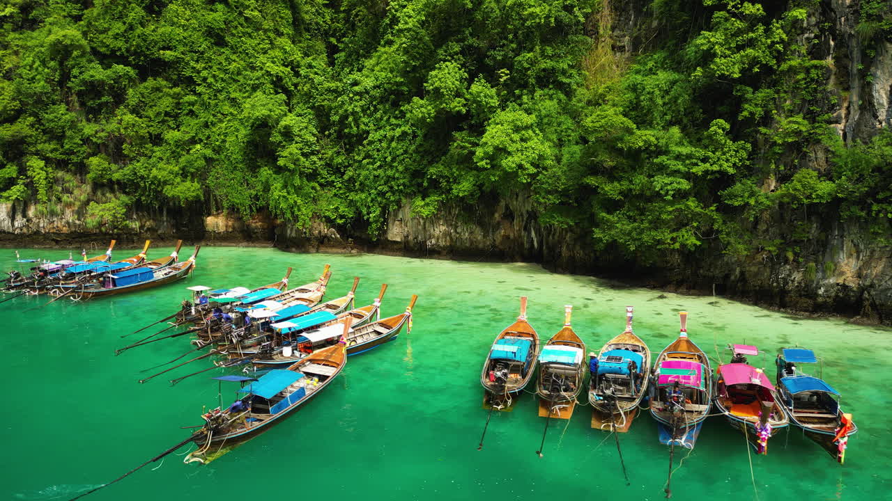 Colorful tourist boats moored in majestic lagoon of Phi Phi islands