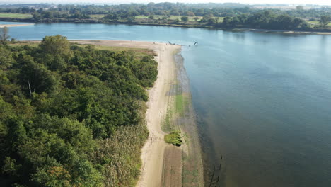 aerial-drone-dolly-shot-pull-away-over-Shell-Bank-Creek-shoreline-in-Brooklyn,-NY