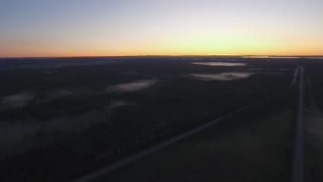 early morning drone shot of two highways meeting with cars passing by