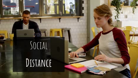 animation of a sign social distance over caucasian people working in a coffee shop