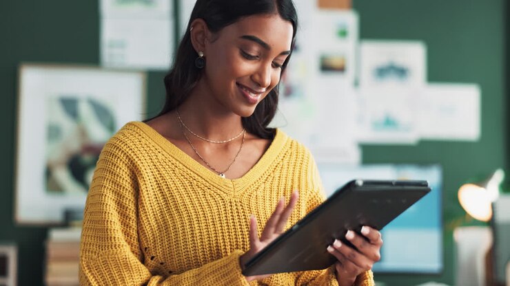 A woman working with a tablet in an office setting