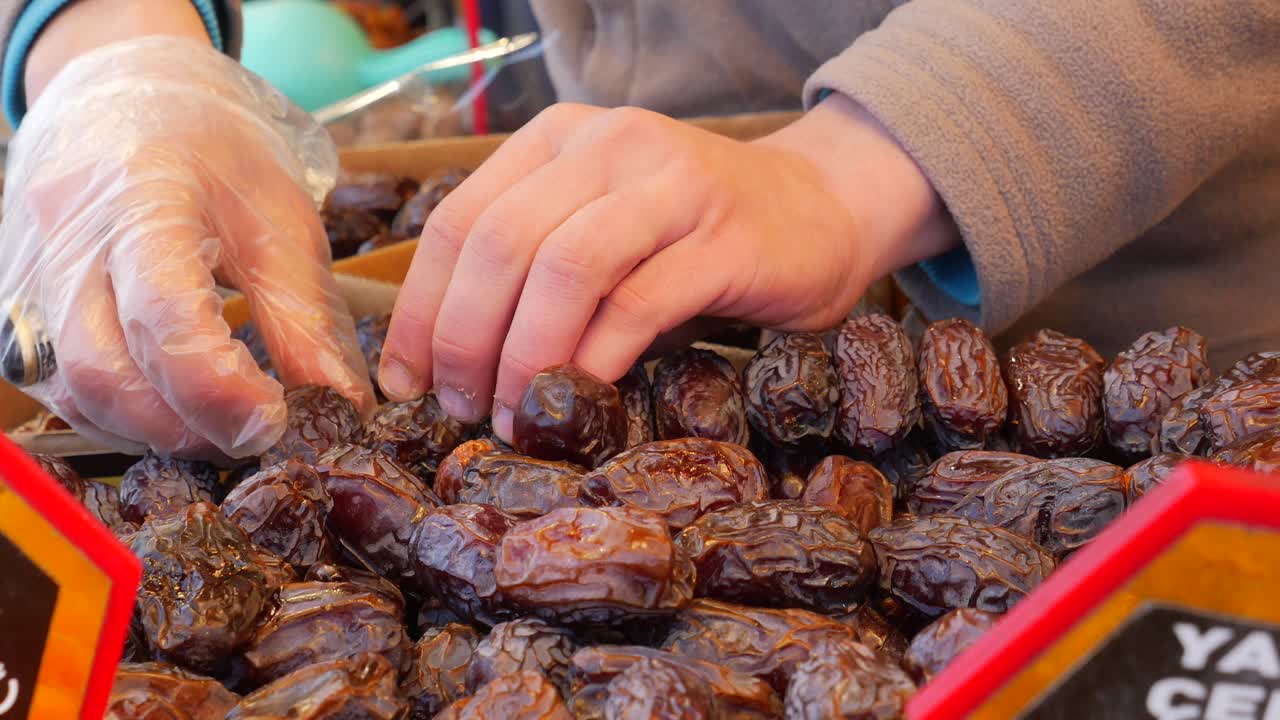 Person buying dates at a market