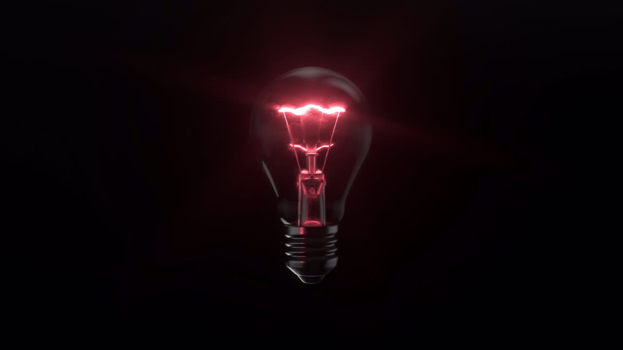 bombilla roja brillante sobre un fondo negro
