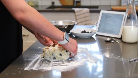 Woman-preparing-cookies-in-kitchen-at-home-4k