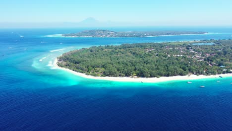 tropical island with palms and resorts, moored boats aerial panorama with copy space