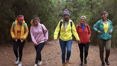 multi generational women walking outdoor having fun during trekking day