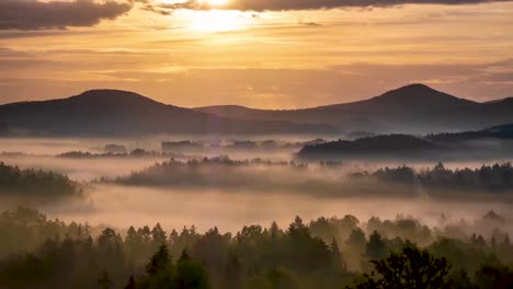 sunset timelapse over mountain and trees with colorful clouds