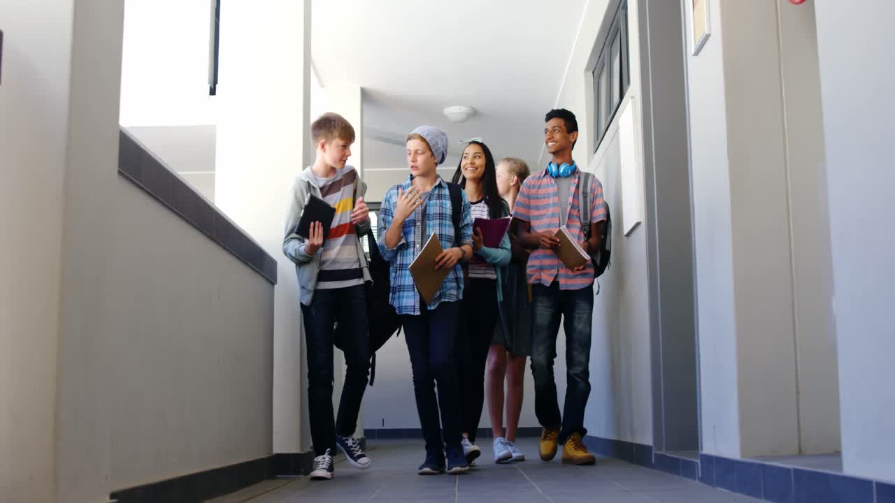 grupo de compañeros de clase caminando por el pasillo