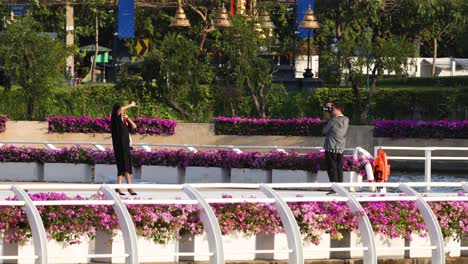 two people meeting on a flower-lined bridge