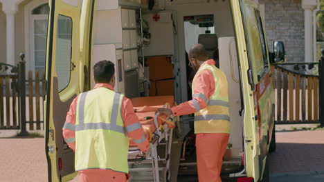 dos paramédicos tomando equipo médico y una camilla de la ambulancia para atender una emergencia