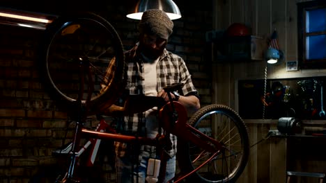 man using a tablet in a bicycle repair shop