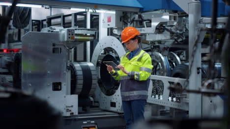 engineer holding transparent tablet computer on industrial manufacture factory.