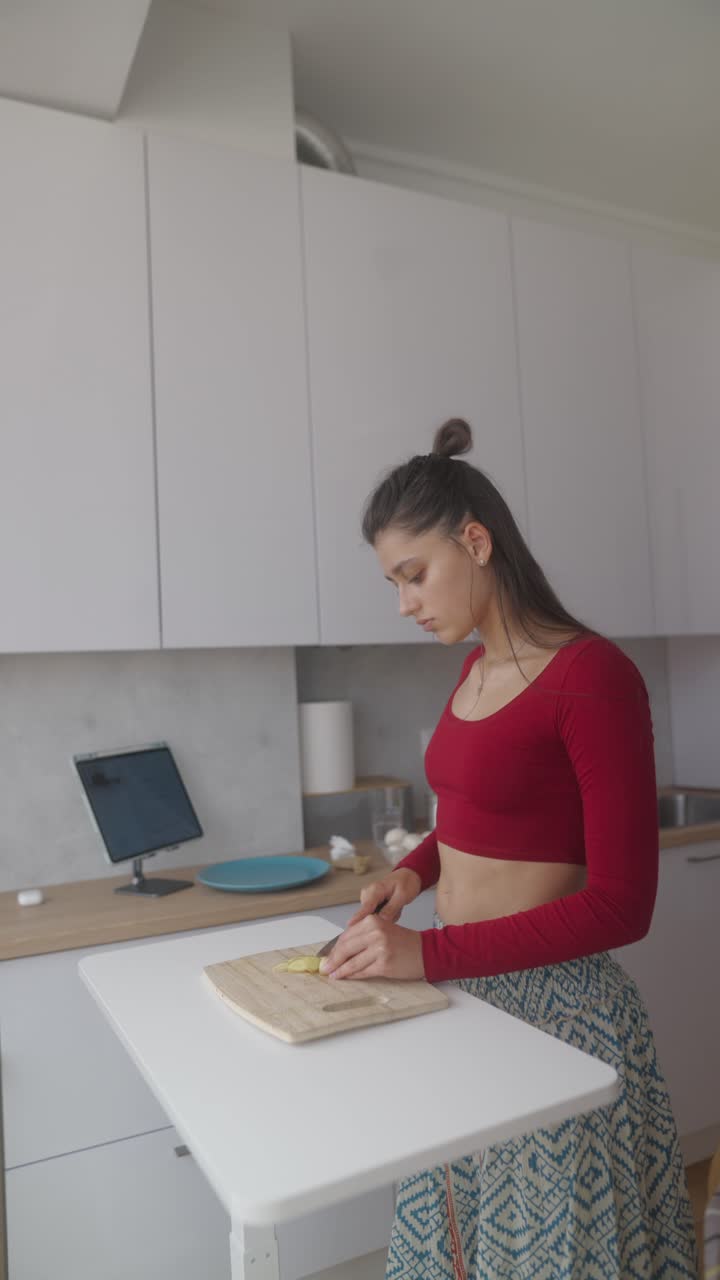 Woman Cooking Ginger in Modern Kitchen