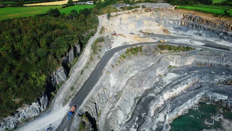 quarry tractor spraying water to keep down dust working quarry in ireland