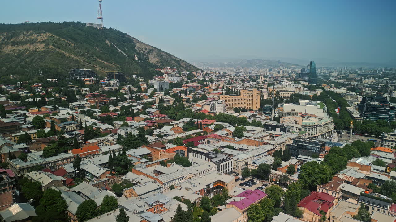 Aerial View of a Vibrant Cityscape with a Mountain and TV Tower
