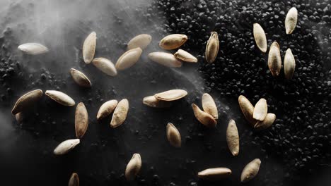 Pumpkin-seeds-are-being-roasted-on-a-bed-of-hot-black-stones,-surrounded-by-steam