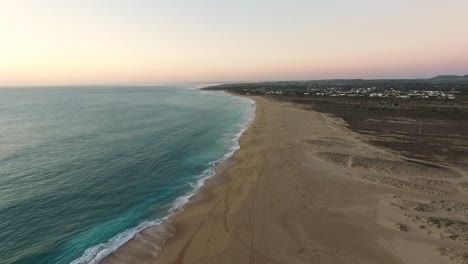 Aerial-top-view-of-the-Atlantic-coast-of-Spain-in-Cadiz-as-the-waves-meet-the-beach-on-a-late-evening