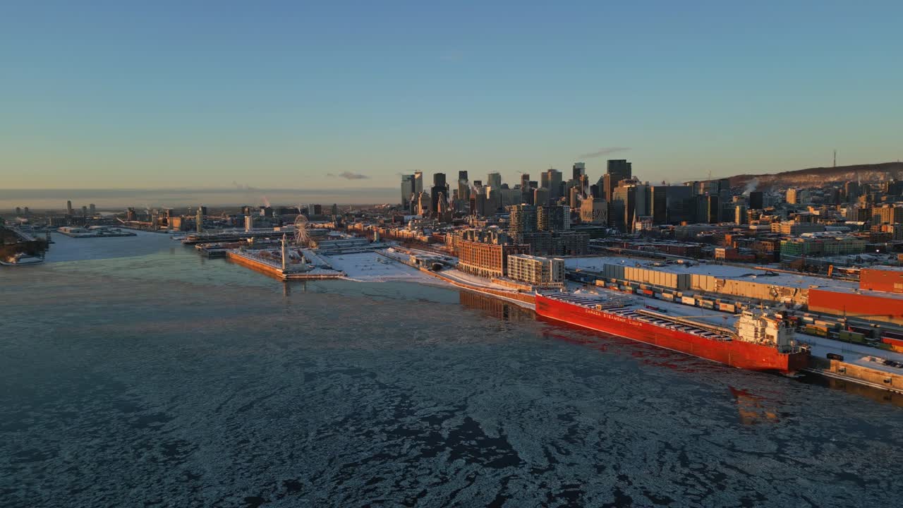 A breathtaking aerial shot of Montreal’s skyline, steel bridge and icy St. Lawrence River, North America, Quebec, Montreal, Canada.