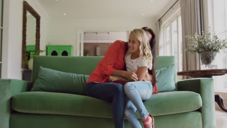 Mother-and-daughter-playing-together-on-sofa-at-home-4k