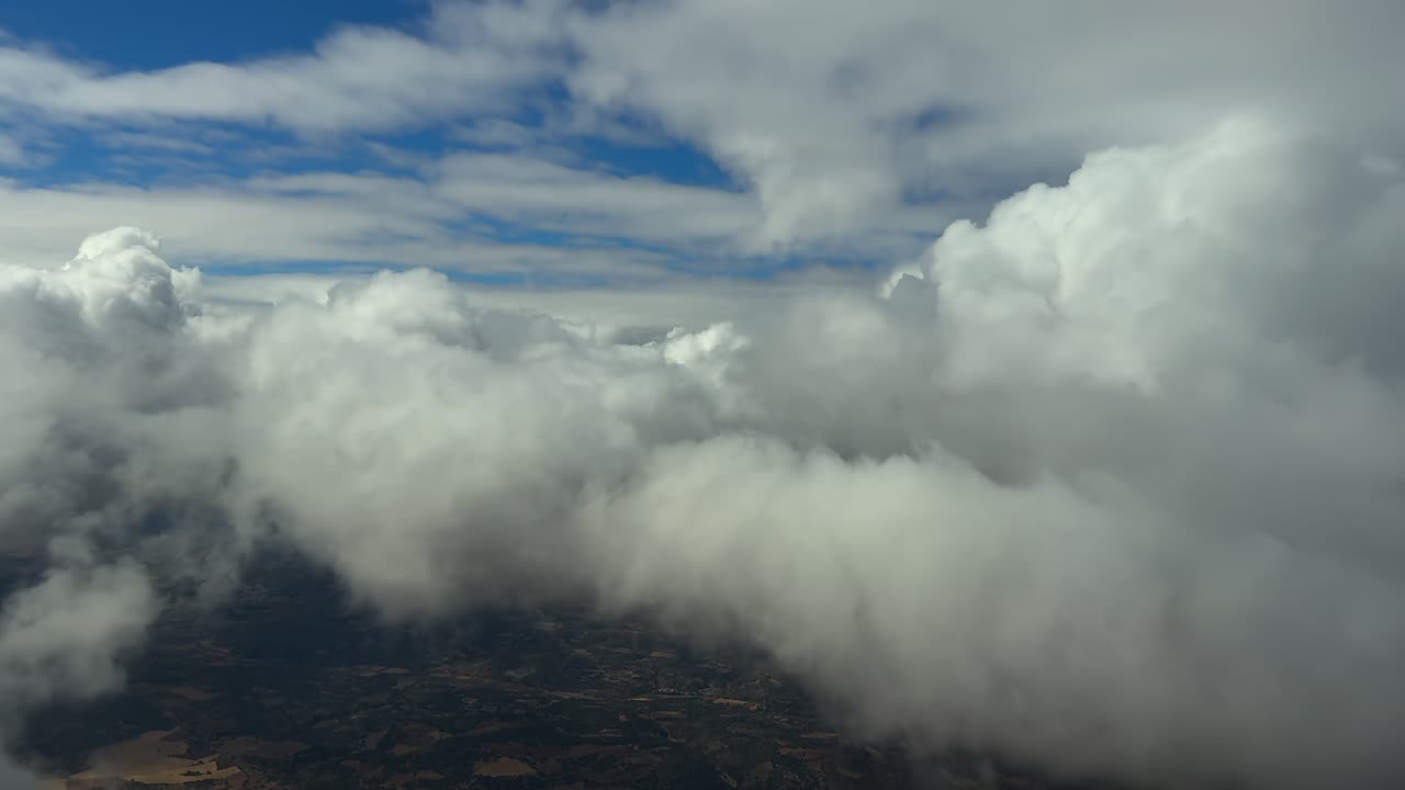 An immersive pilot’s eye view in a supersonic speed flight experience through and into fluffy clouds at sunset. Footage taken from a the cockpit of a jet