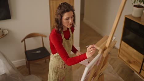 woman painting on canvas in an art studio