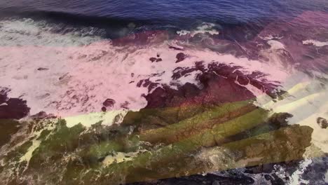 Digital-composition-of-waving-germany-flag-against-aerial-view-of-sea-waves