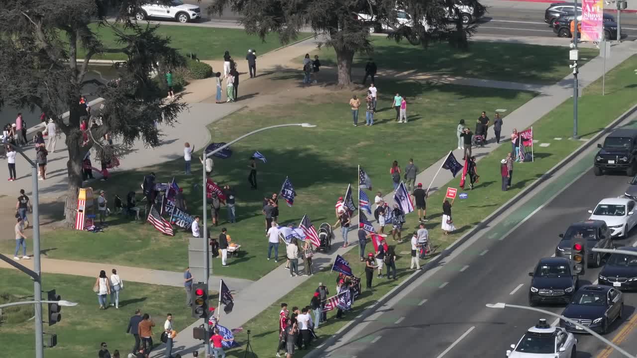Rising aerial of people supporting Donald Trump at rally against Harris