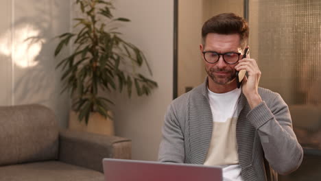businessman talking on phone at home