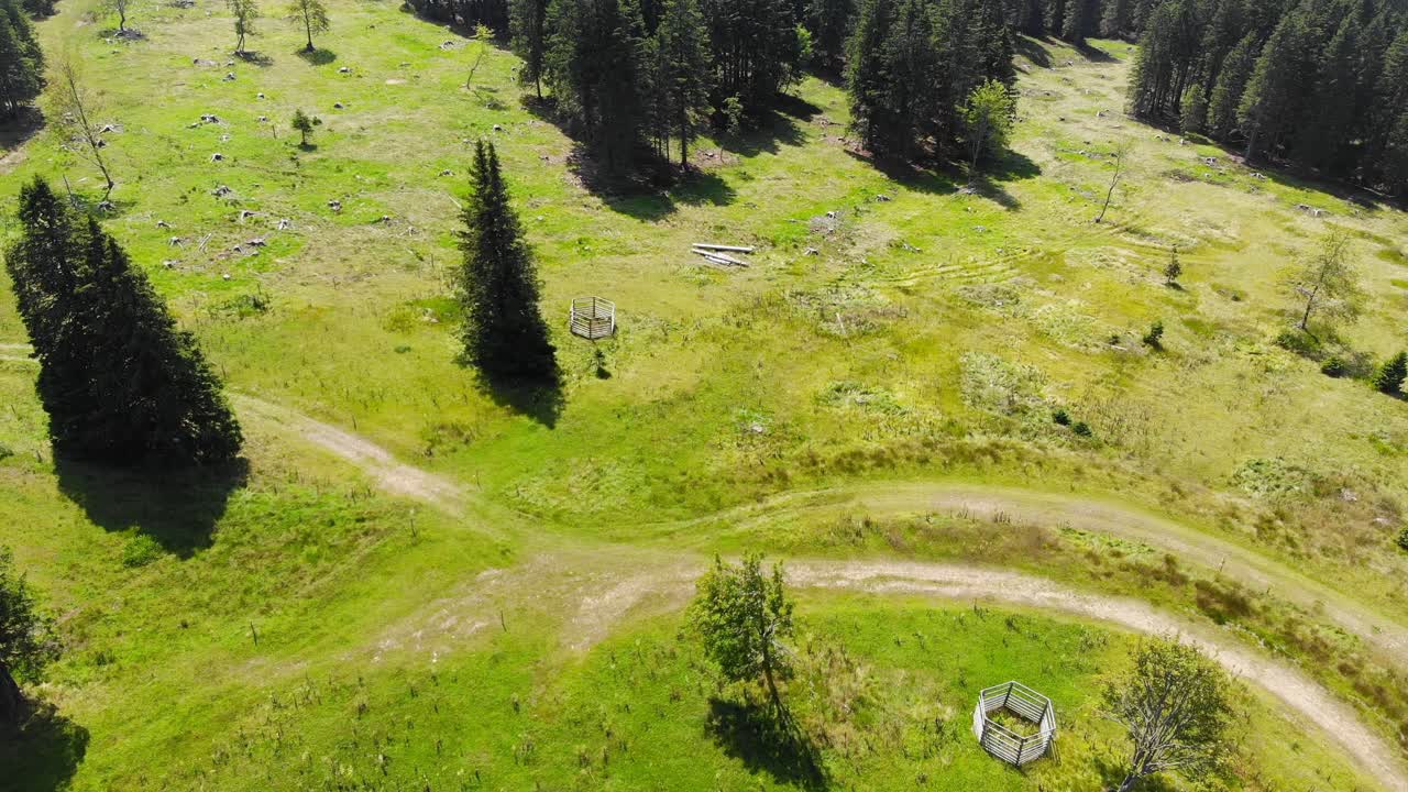 Rogla Slovenia resort grounds with forest hike trails during spring season, Aerial flyover shot