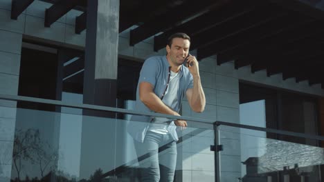 confident man talking phone in modern building. connection lifestyle