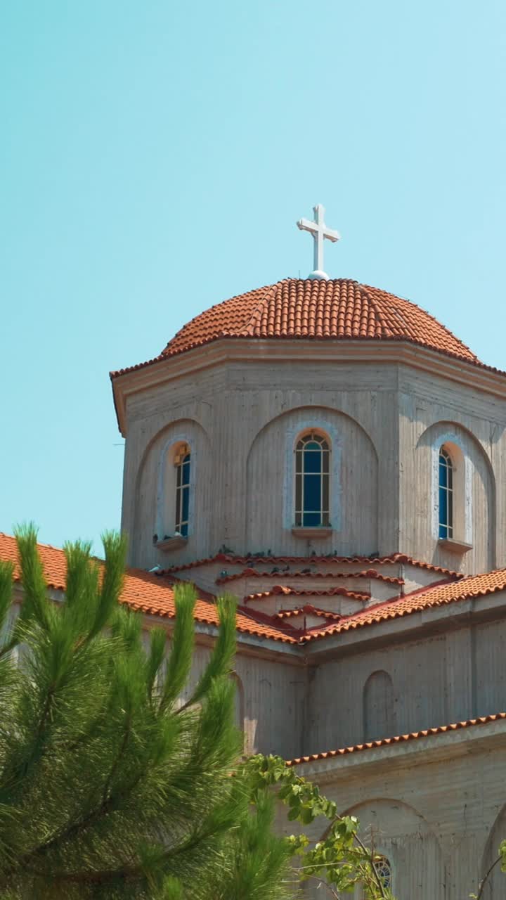 Exterior view of a church with a cross on top of its dome