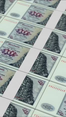 vertical video of 10 deutsche mark germany banknotes printing by a money press