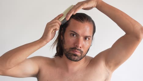 man brushing his long hair