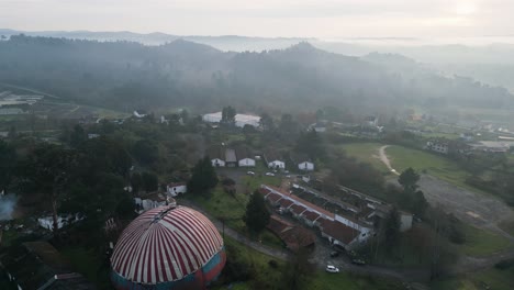 misty morning clouds on mountains behind benposta circus troupe