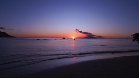 beautiful sunset on beau vallon beach, mahe seychelles, tourist swimming, calm sea and beautiful scenery 1