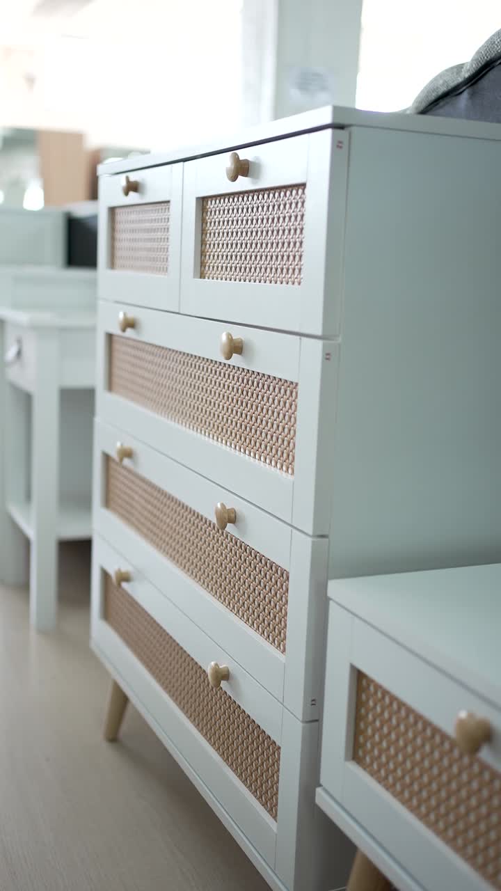 Elegant drawer unit featuring a sleek design and natural fiber accents, beautifully placed in a bright, airy room. Perfect for organizing and enhancing decor