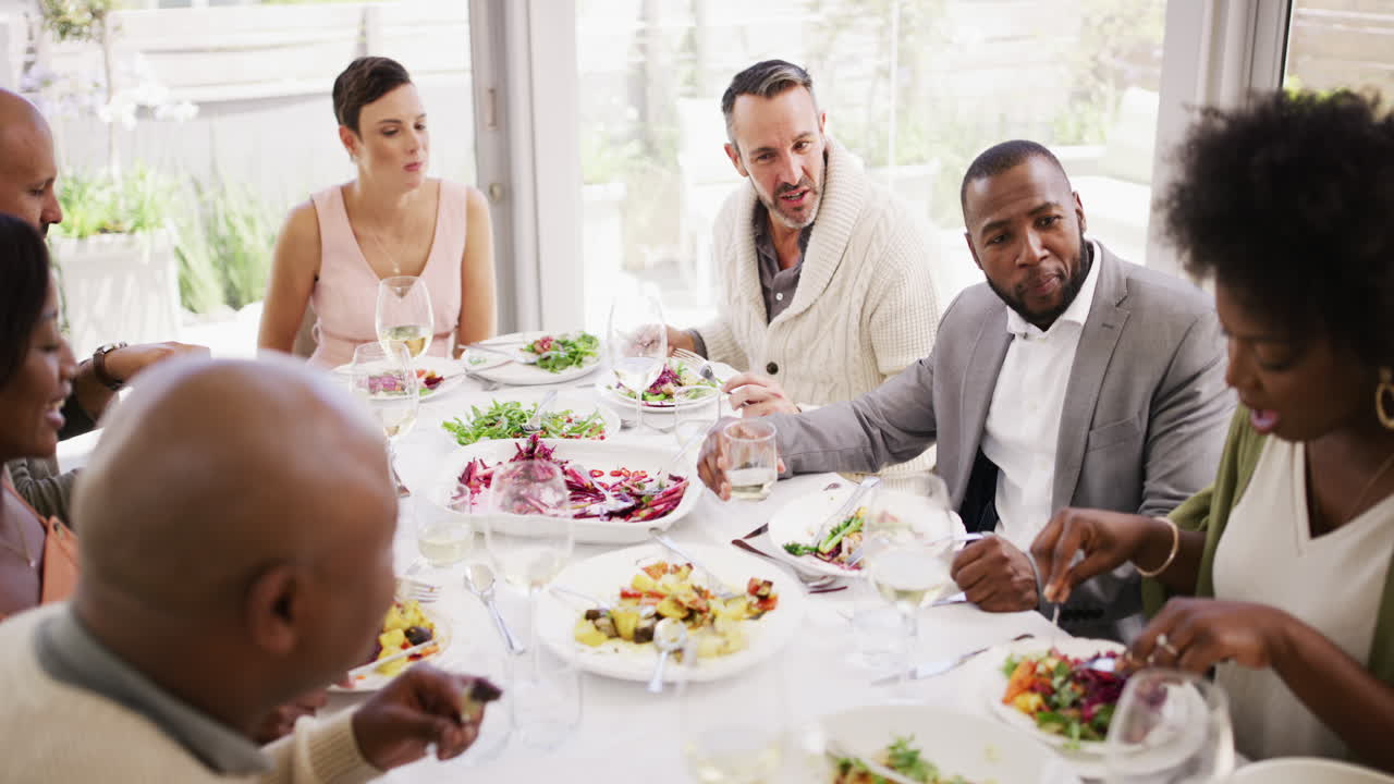 Diverse and mature group of friends eating