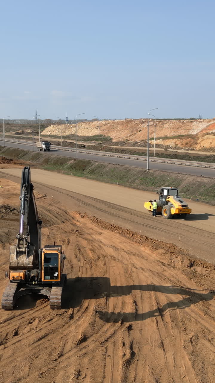 Construction Site with Excavator and Road Roller