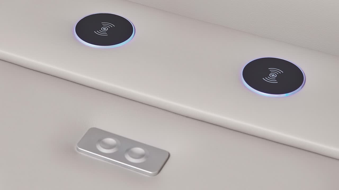 Camera pushes into arm-panel ports and buttons on modern white leather couch